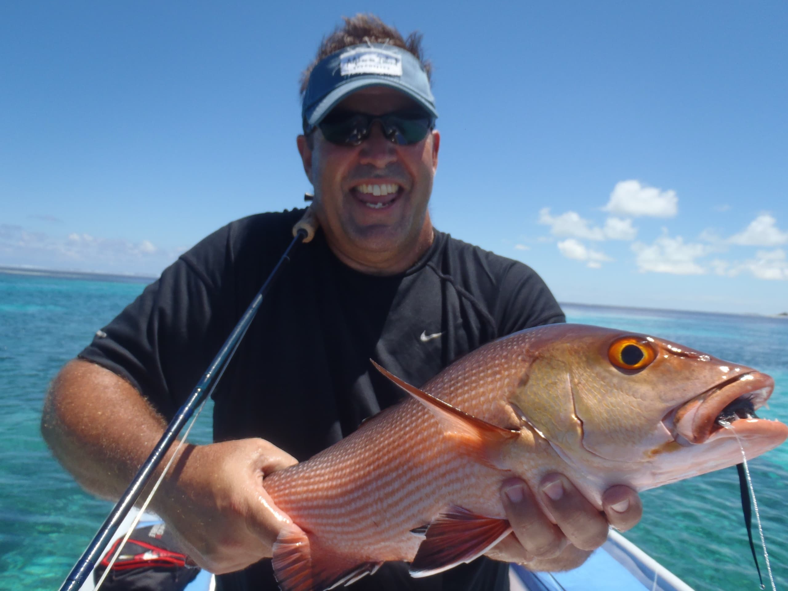A fish brought aboard over blue water off the Mozambican coast